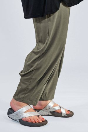 The model in this photo is wearing a pair of Noen jersey harem trousers in dark olive