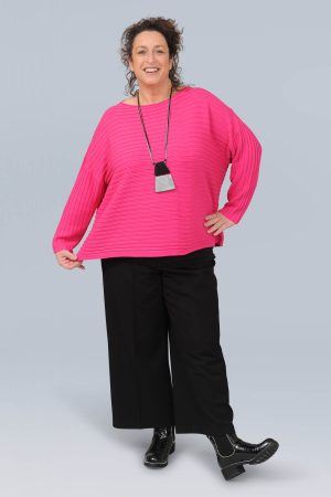 The model in this photo is wearing a short fuchsia jumper from German plus size specialists Doris Streich from Bakou in London