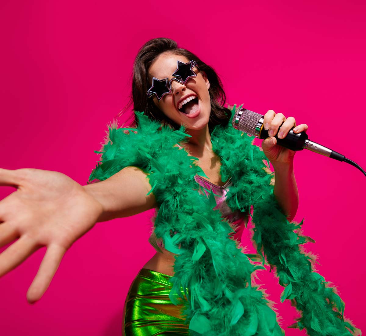 Overly showy singer with star sunglasses and green feather bower