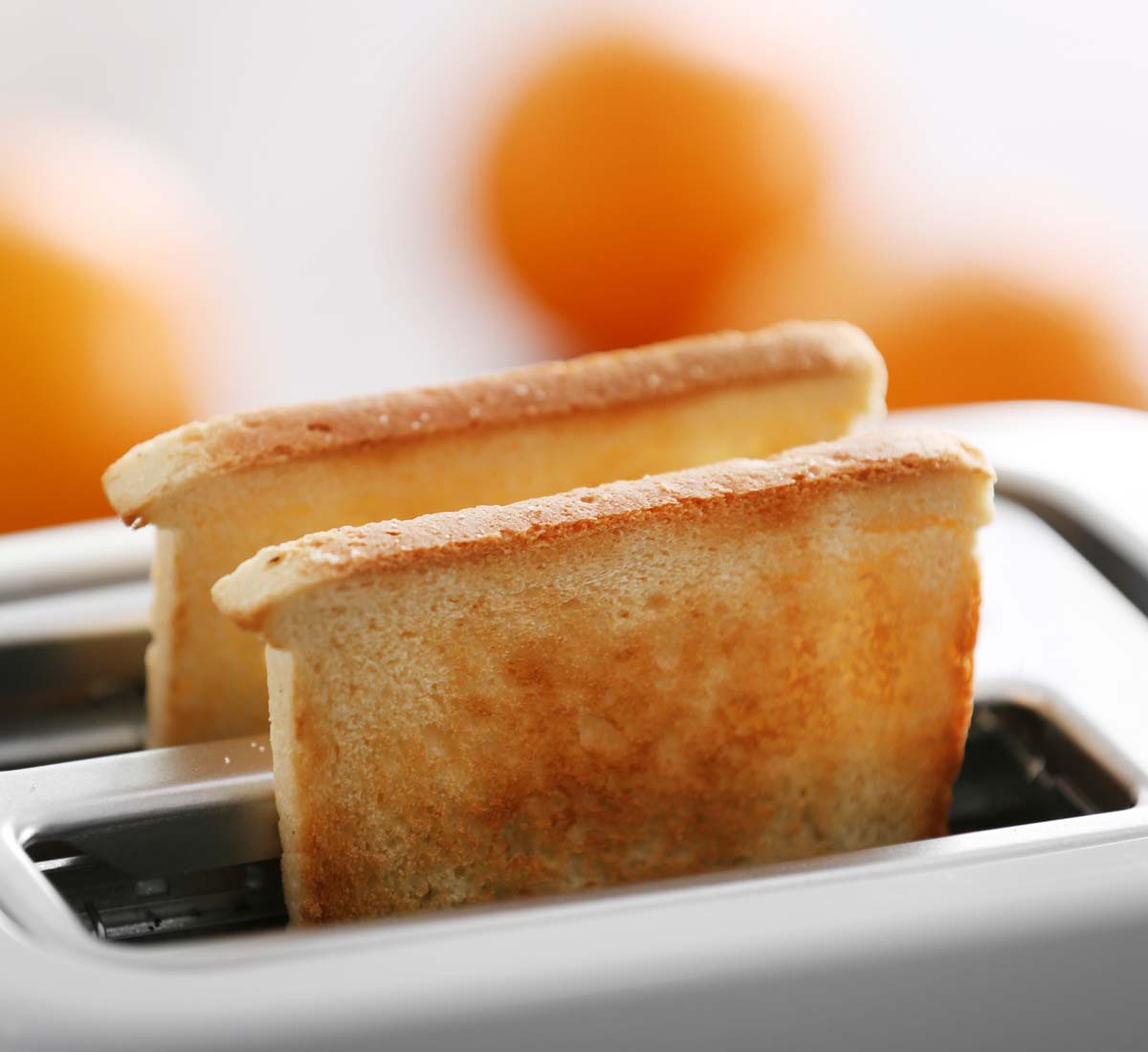 Toaster with two nicely brown pieces of toast that have popped up