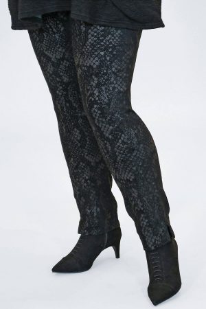 The model in this photo is wearing a pair of narrow stretch Robell Rose snake print trousers