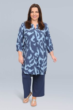 The model in this photo is wearing a long tunic or dress in funky abstract blue design from German plus size designers Via Appia Due at Bakou London